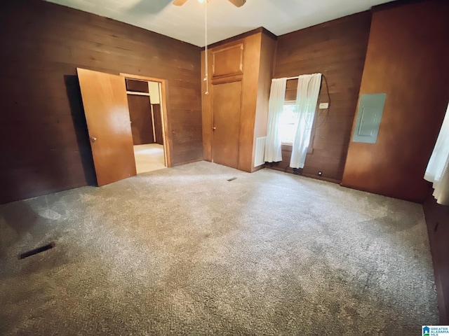 672 Websters Chapel Rd, Wellington, AL 36279 - unfurnished bedroom with wood walls, carpet, and a ceiling fan