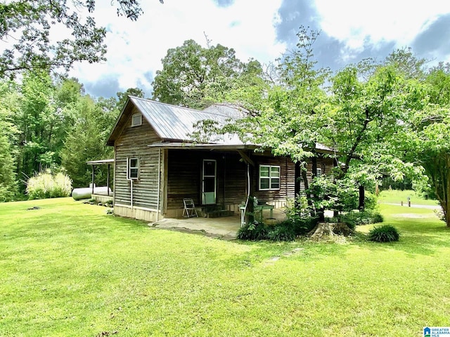 672 Websters Chapel Rd, Wellington, AL 36279 - view of home's exterior featuring a yard and a patio area