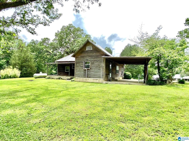 672 Websters Chapel Rd, Wellington, AL 36279 - back of house featuring a lawn, an attached carport, and covered porch
