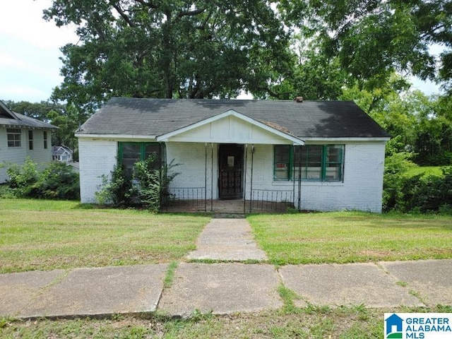 16 Norwood Cir, Birmingham, AL 35234 - view of front of house featuring brick siding, covered porch, and a front lawn