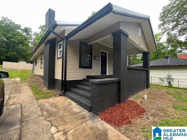 2732 29th St, Birmingham, AL 35208 - view of front facade featuring a chimney and a porch
