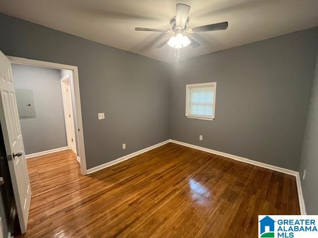2732 29th St, Birmingham, AL 35208 - spare room featuring ceiling fan, wood finished floors, and electric panel