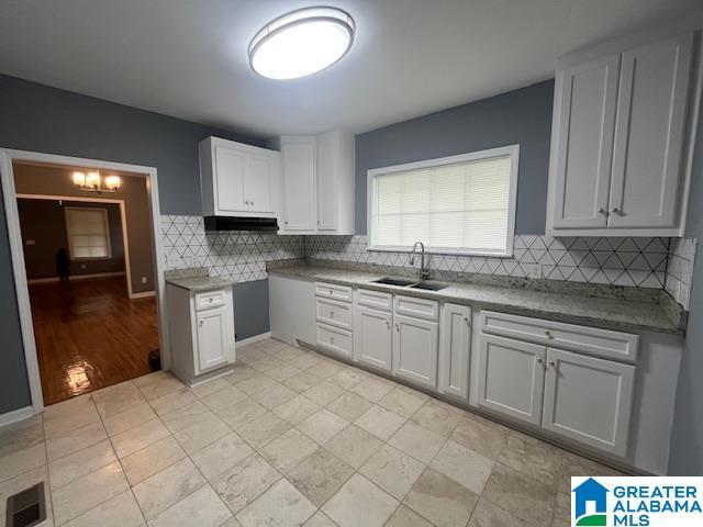 2732 29th St, Birmingham, AL 35208 - kitchen featuring decorative backsplash and white cabinets