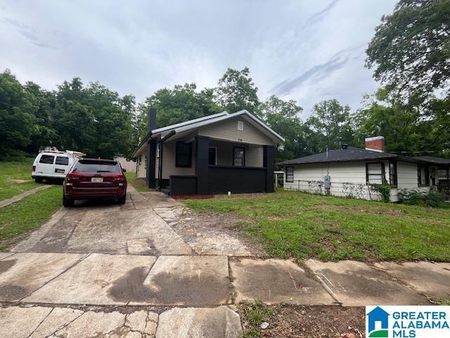 2732 29th St, Birmingham, AL 35208 - bungalow-style house featuring driveway and a front yard