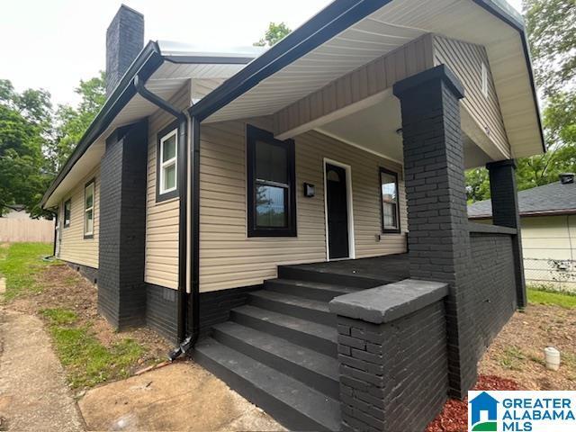 2732 29th St, Birmingham, AL 35208 - view of front facade with a chimney and a porch