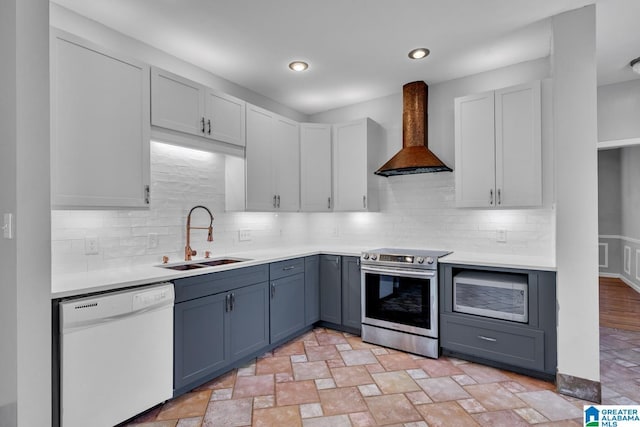 7741 John Pelham Trl, Mccalla, AL 35111 - kitchen featuring appliances with stainless steel finishes, premium range hood, light countertops, stone finish floors, and backsplash