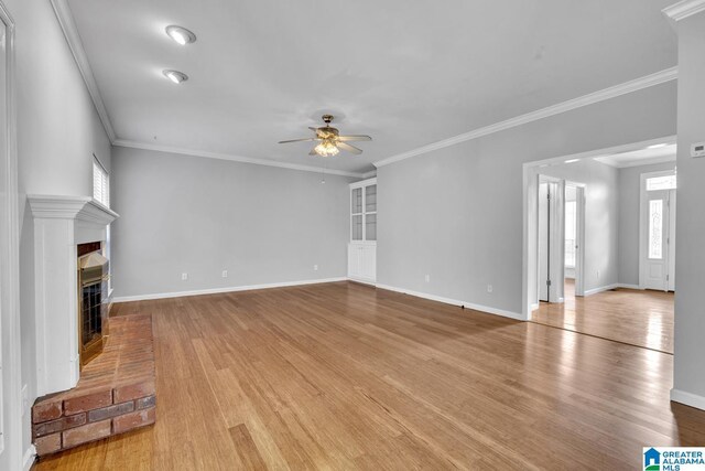 7741 John Pelham Trl, Mccalla, AL 35111 - unfurnished living room with ceiling fan, a fireplace, wood finished floors, and crown molding