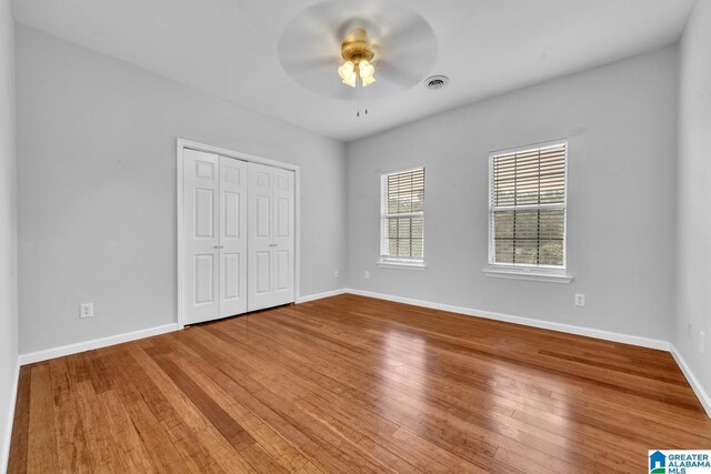 7741 John Pelham Trl, Mccalla, AL 35111 - unfurnished bedroom featuring wood finished floors, a closet, and a ceiling fan