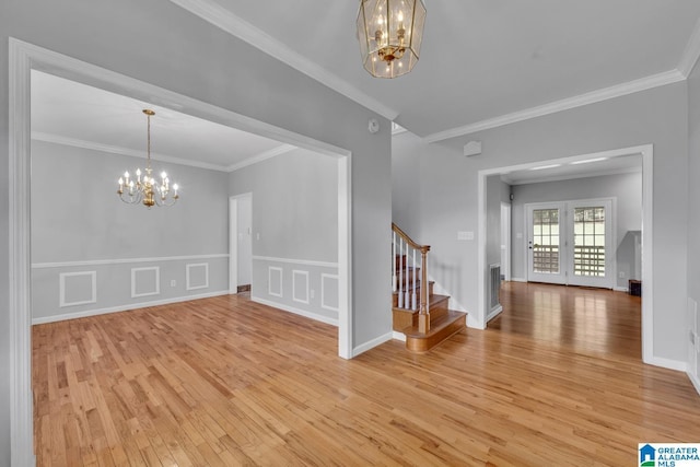 7741 John Pelham Trl, Mccalla, AL 35111 - entrance foyer with a chandelier, light wood-type flooring, stairway, crown molding, and a wainscoted wall