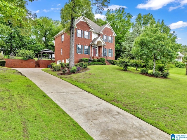 7741 John Pelham Trl, Mccalla, AL 35111 - view of front of house with brick siding, concrete driveway, a gazebo, and a front lawn