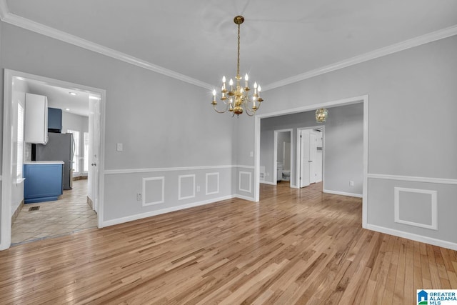 7741 John Pelham Trl, Mccalla, AL 35111 - spare room with a chandelier, crown molding, and light wood-type flooring