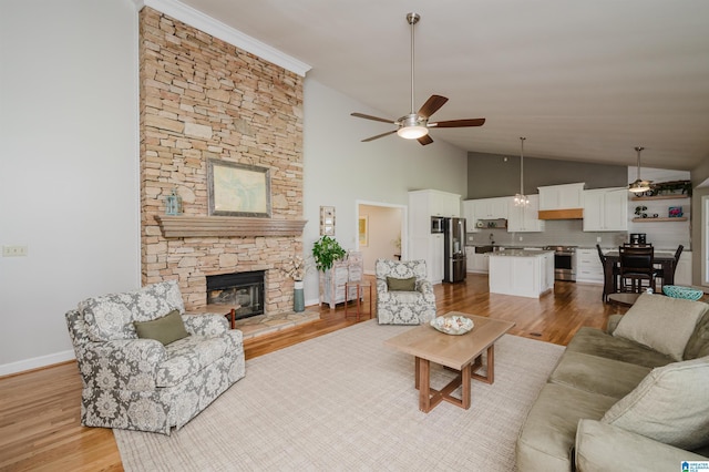 212 Bellbrook Dr, Cropwell, AL 35054 - living room with ceiling fan, light wood-style flooring, a fireplace, and high vaulted ceiling