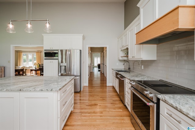 212 Bellbrook Dr, Cropwell, AL 35054 - kitchen featuring appliances with stainless steel finishes, custom range hood, white cabinetry, backsplash, and light wood-type flooring