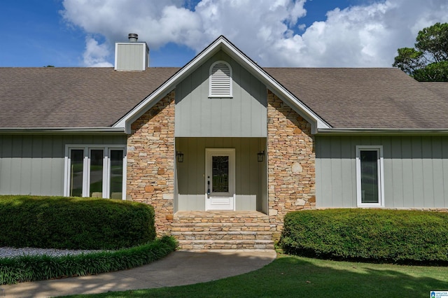 212 Bellbrook Dr, Cropwell, AL 35054 - doorway to property with stone siding, a shingled roof, and a chimney