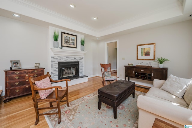 212 Bellbrook Dr, Cropwell, AL 35054 - living room with ornamental molding, a tray ceiling, light wood-style flooring, recessed lighting, and a fireplace