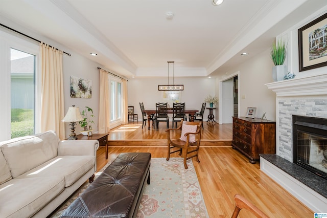 212 Bellbrook Dr, Cropwell, AL 35054 - living room featuring light wood-type flooring, a raised ceiling, a fireplace, recessed lighting, and crown molding