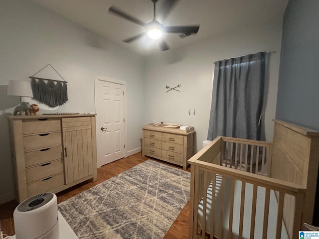 5433 Wisteria Trce, Trussville, AL 35173 - bedroom with wood finished floors, a nursery area, and a ceiling fan