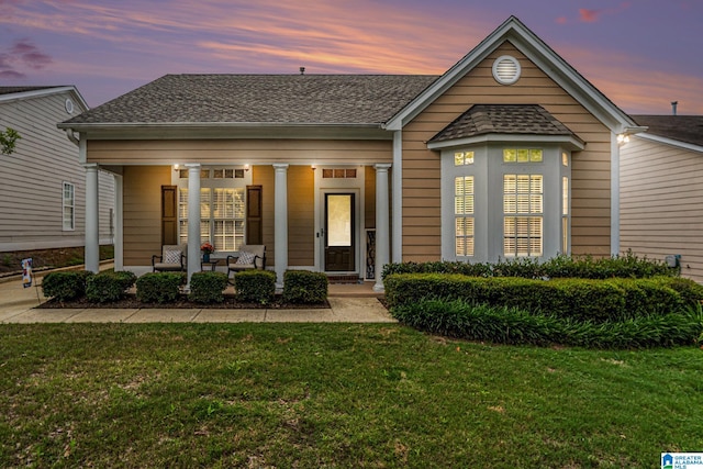 5433 Wisteria Trce, Trussville, AL 35173 - view of front facade featuring covered porch, a front lawn, and roof with shingles