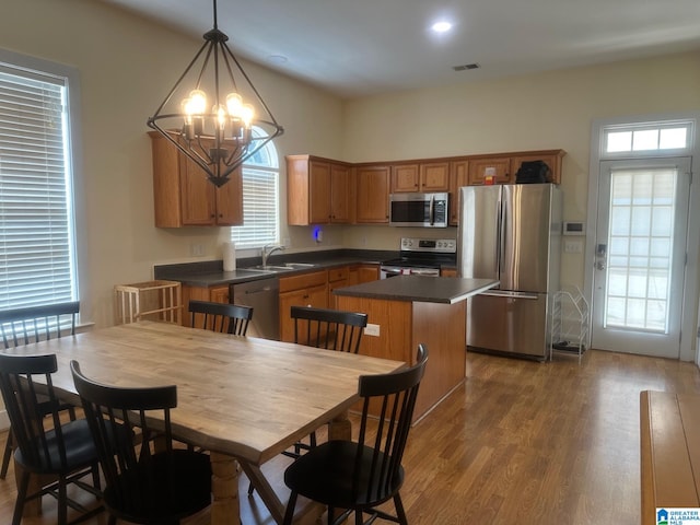 5433 Wisteria Trce, Trussville, AL 35173 - kitchen featuring appliances with stainless steel finishes, dark countertops, wood finished floors, and a kitchen island