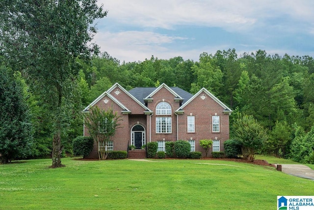 214 Quail Ridge Rd, Helena, AL 35080 - view of front of house with a front yard, brick siding, and a wooded view