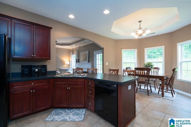 214 Quail Ridge Rd, Helena, AL 35080 - kitchen with black appliances, a raised ceiling, arched walkways, dark countertops, and a peninsula