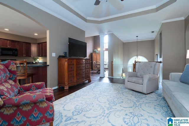 214 Quail Ridge Rd, Helena, AL 35080 - living area with wood finished floors, ceiling fan, arched walkways, crown molding, and a chandelier