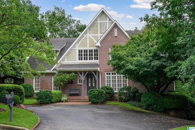 101 Mountain Ave, Mountain Brook, AL 35213 - english style home with brick siding, covered porch, and a shingled roof