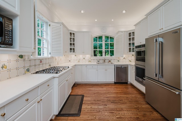 101 Mountain Ave, Mountain Brook, AL 35213 - kitchen featuring stainless steel appliances, white cabinets, decorative backsplash, glass insert cabinets, and recessed lighting