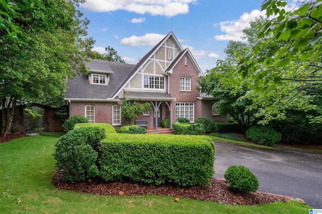101 Mountain Ave, Mountain Brook, AL 35213 - english style home featuring brick siding, a front lawn, and a shingled roof