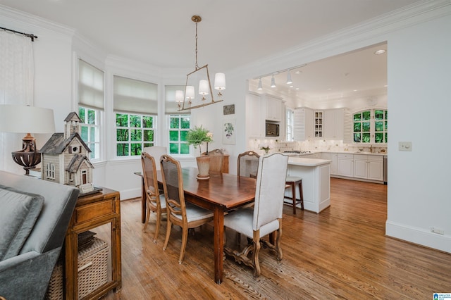 101 Mountain Ave, Mountain Brook, AL 35213 - dining area featuring ornamental molding, a chandelier, and wood finished floors