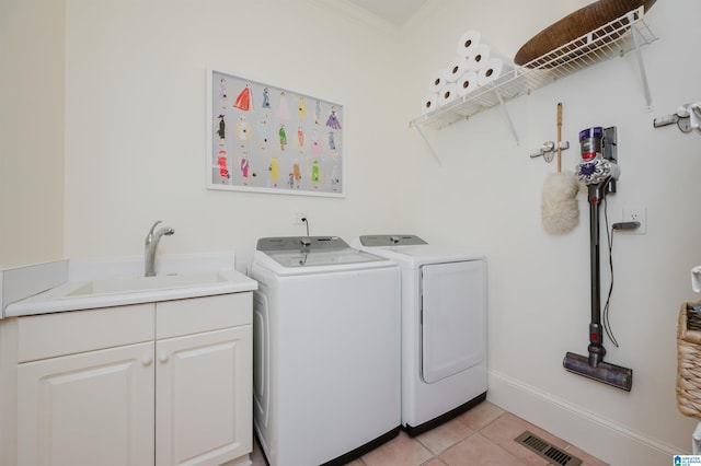 101 Mountain Ave, Mountain Brook, AL 35213 - laundry room featuring washing machine and dryer, light tile patterned flooring, crown molding, and cabinet space