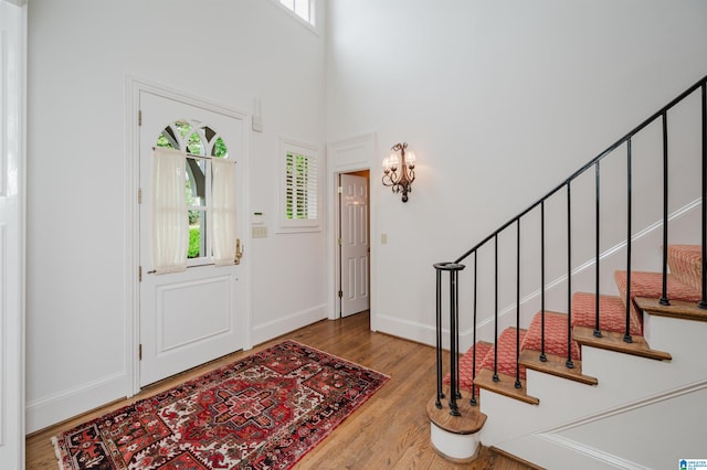101 Mountain Ave, Mountain Brook, AL 35213 - foyer with healthy amount of natural light, wood finished floors, stairs, and a towering ceiling
