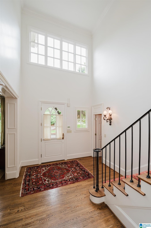 101 Mountain Ave, Mountain Brook, AL 35213 - entrance foyer with a towering ceiling, ornamental molding, wood finished floors, and stairway
