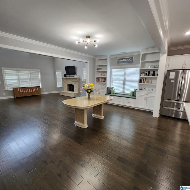 3052 Simms Lndg, Pelham, AL 35124 - living area featuring crown molding, a chandelier, dark wood-type flooring, and a fireplace with raised hearth