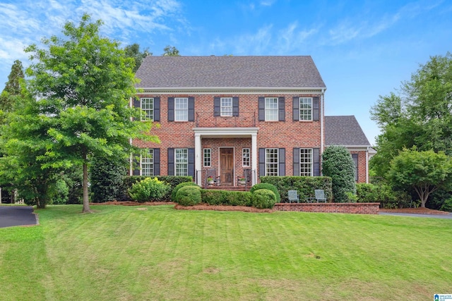 1528 Wellington Rd, Homewood, AL 35209 - colonial home featuring brick siding and a front yard