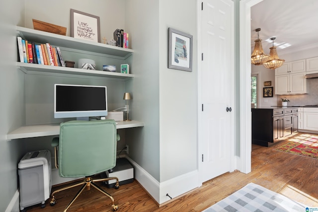 1528 Wellington Rd, Homewood, AL 35209 - office area featuring light wood-type flooring, built in study area, and a chandelier