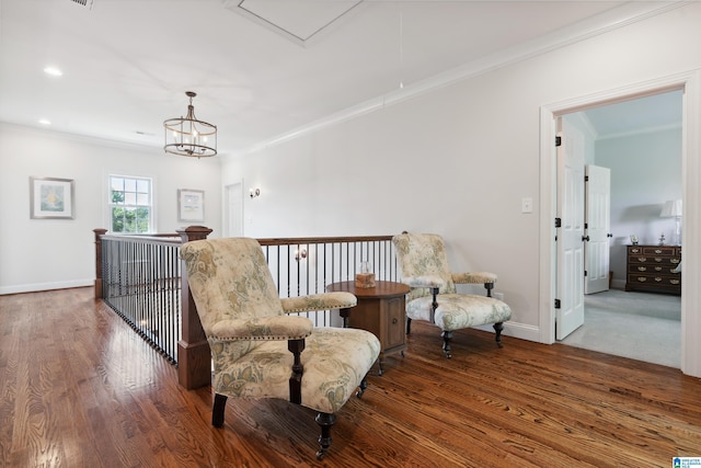 1528 Wellington Rd, Homewood, AL 35209 - living area with ornamental molding, wood finished floors, an upstairs landing, a chandelier, and attic access