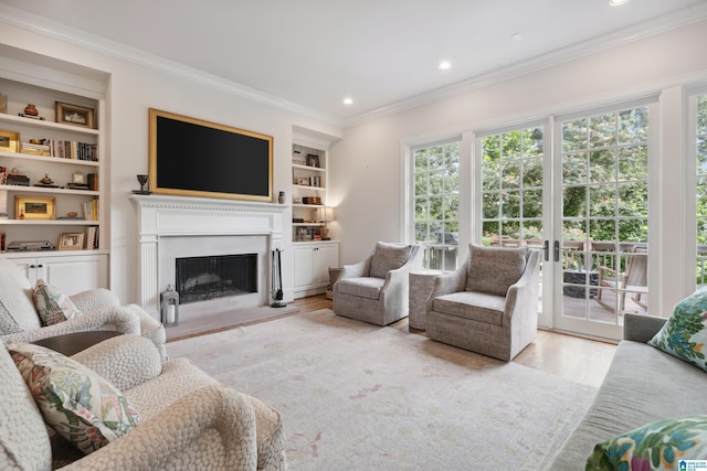 1528 Wellington Rd, Homewood, AL 35209 - living room featuring crown molding, wood finished floors, built in shelves, a fireplace with raised hearth, and recessed lighting