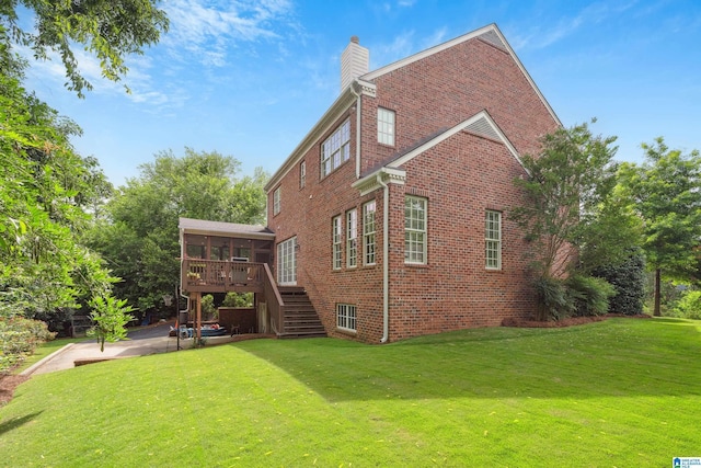 1528 Wellington Rd, Homewood, AL 35209 - rear view of house featuring brick siding, stairway, a sunroom, a lawn, and a chimney