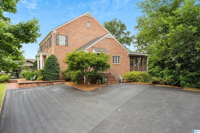 1528 Wellington Rd, Homewood, AL 35209 - view of side of home with a sunroom and brick siding
