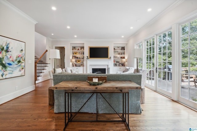 1528 Wellington Rd, Homewood, AL 35209 - living area featuring crown molding, a fireplace, stairway, built in shelves, and recessed lighting