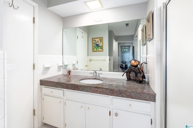3224 Monte Doro Dr, Hoover, AL 35216 - bathroom with vanity, a wainscoted wall, and tile walls