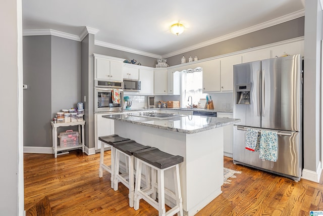 664 Jent Rd, Cordova, AL 35550 - kitchen featuring black appliances, white cabinets, a kitchen island, crown molding, and wood finished floors