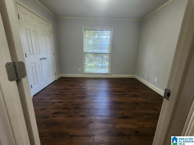 2030 Carraway St, Birmingham, AL 35235 - unfurnished bedroom featuring dark wood finished floors and crown molding