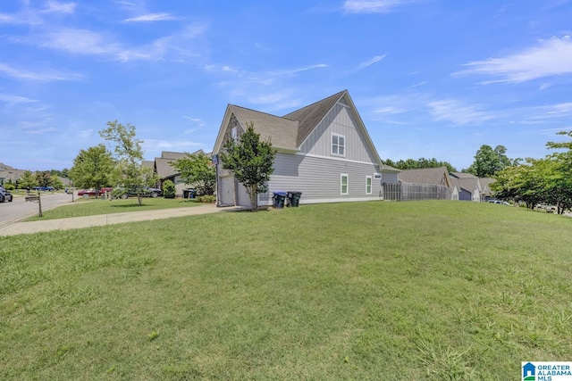 2165 Overlook Pl, Trussville, AL 35173 - view of side of property featuring board and batten siding, driveway, a yard, and an attached garage