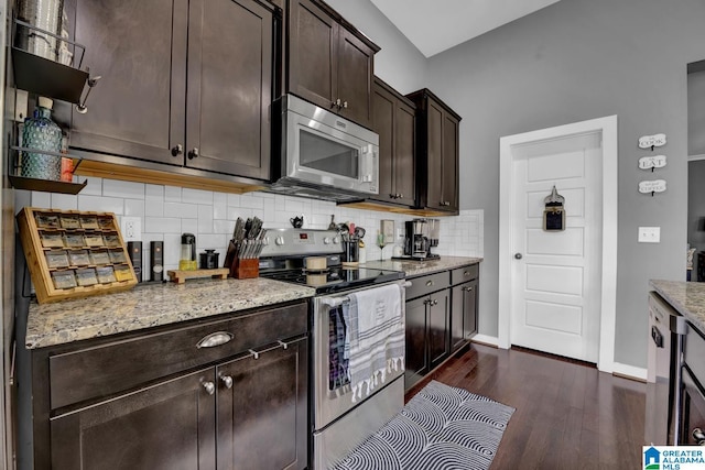 2165 Overlook Pl, Trussville, AL 35173 - kitchen featuring stainless steel appliances, dark brown cabinets, backsplash, dark wood finished floors, and light stone countertops