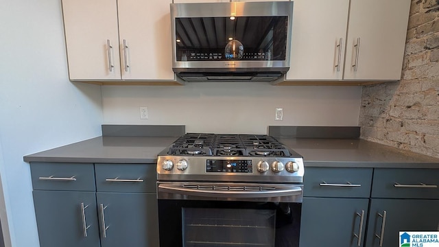 1801 2nd Ave N Unit 406, Birmingham, AL 35203 - kitchen with stainless steel appliances, dark countertops, and gray cabinetry