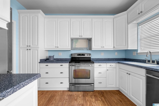 147 Old Brook Pl, Birmingham, AL 35242 - kitchen featuring appliances with stainless steel finishes, dark countertops, white cabinetry, and light wood finished floors
