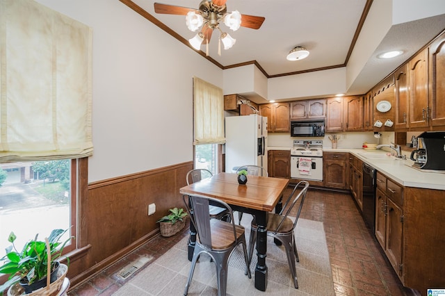 2418 Richelieu Ln, Hoover, AL 35216 - kitchen with black appliances, ornamental molding, light countertops, a wainscoted wall, and a ceiling fan