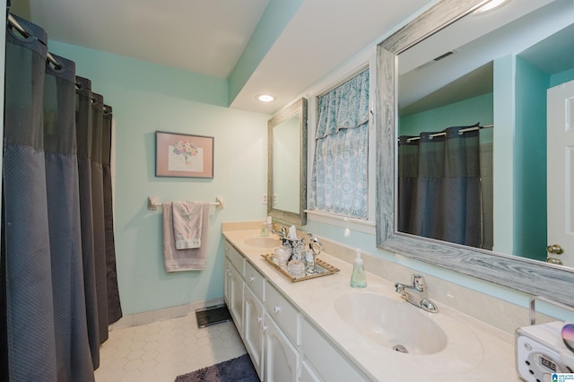 2418 Richelieu Ln, Hoover, AL 35216 - full bath featuring double vanity, tile patterned floors, recessed lighting, and curtained shower